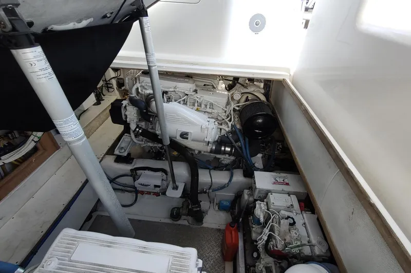 Never Enough Yacht Photos Pics Engine compartment of 2017 Out Island SeaTek 36 Express boat, showcasing mechanical components.