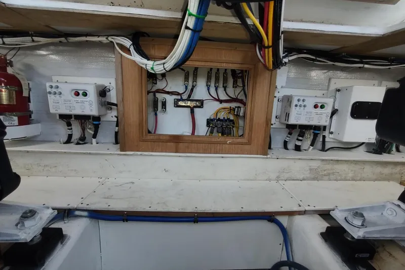 Never Enough Yacht Photos Pics Electrical panel of 2017 Out Island SeaTek 36 Express boat, showcasing wiring and controls.
