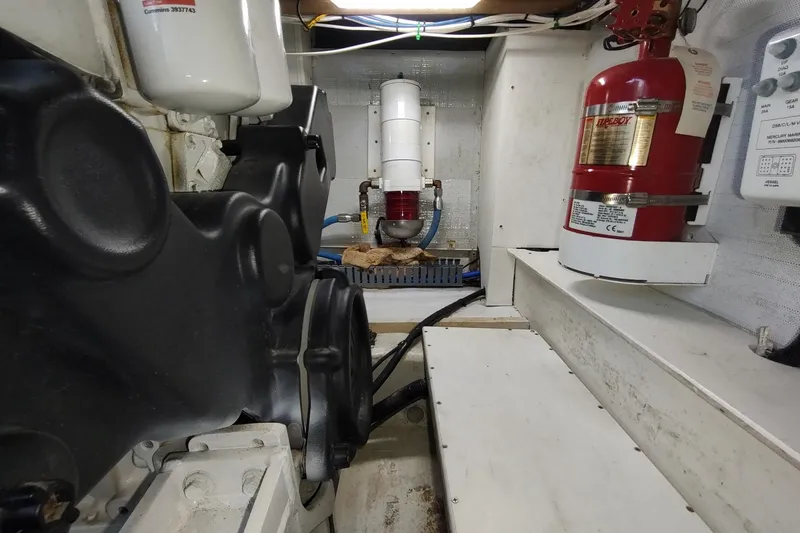 Never Enough Yacht Photos Pics Engine room of 2017 Out Island SeaTek 36 Express with fire extinguisher and mechanical components.