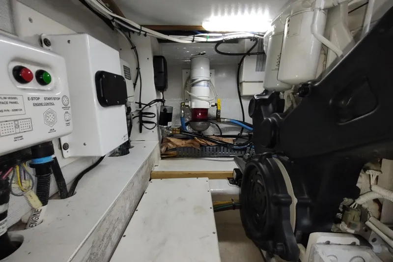 Never Enough Yacht Photos Pics Engine room of 2017 Out Island SeaTek 36 Express with control panel and machinery.