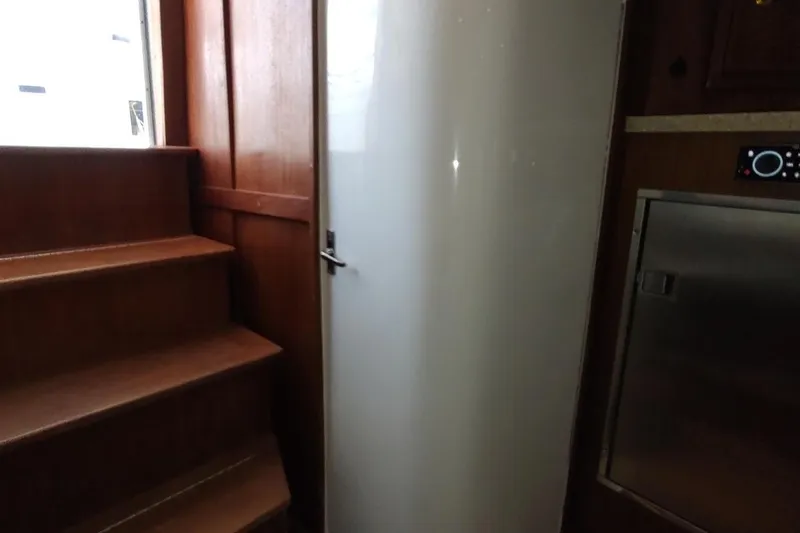 Never Enough Yacht Photos Pics Interior of 2017 Out Island SeaTek 36 Express with wooden stairs and modern appliances.