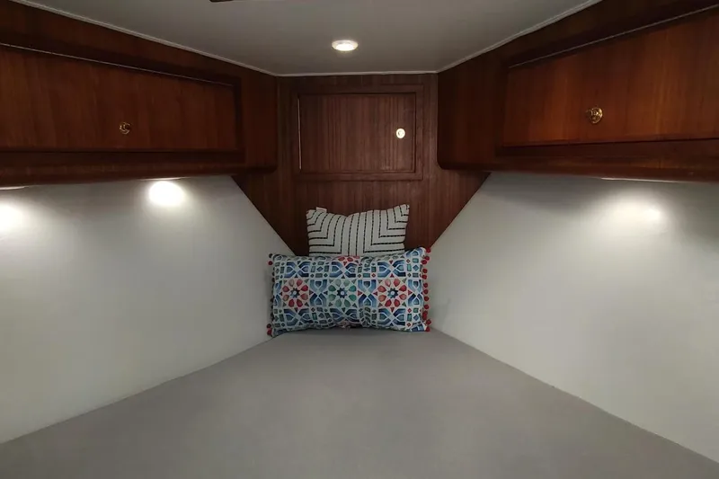 Never Enough Yacht Photos Pics Cozy cabin interior of 2017 Out Island SeaTek 36 Express with decorative pillows.