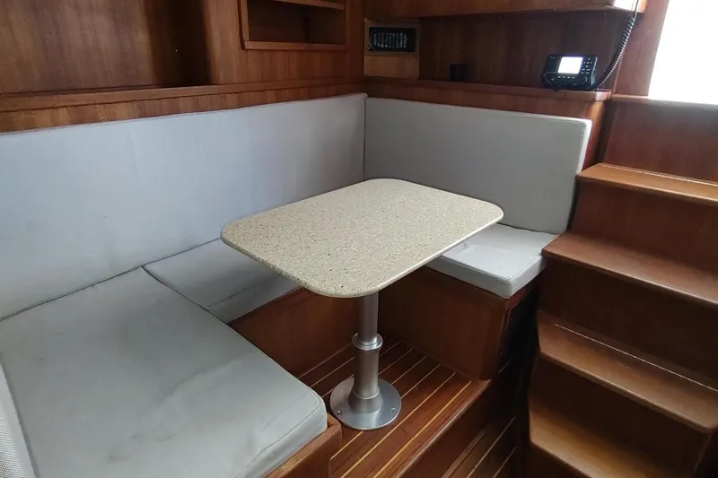 Never Enough Yacht Photos Pics 2017 Out Island SeaTek 36 Express interior with cozy seating and wooden accents.
