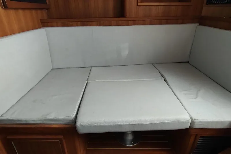 Never Enough Yacht Photos Pics 2017 Out Island SeaTek 36 Express interior with cushioned seating area.