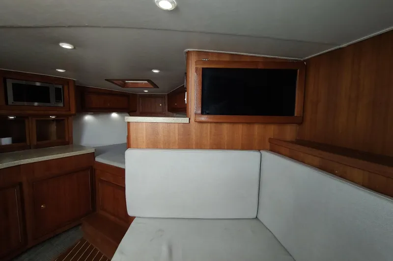 Never Enough Yacht Photos Pics 2017 Out Island SeaTek 36 Express cabin interior with wood finish and modern amenities.