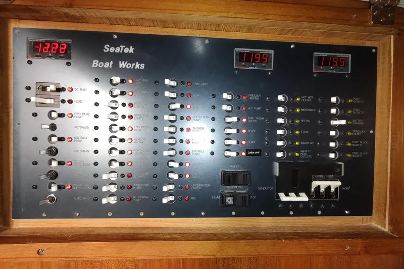 Never Enough Yacht Photos Pics Electrical control panel of 2017 Out Island SeaTek 36 Express boat with switches and indicators.