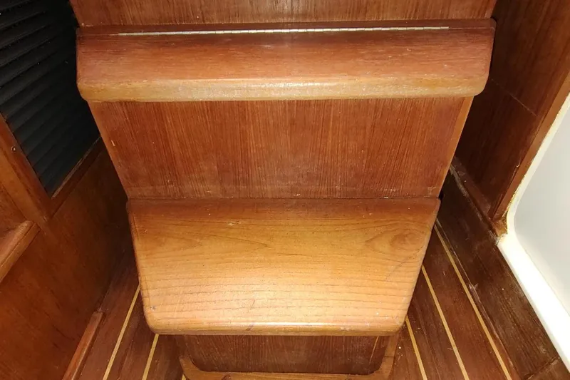 Never Enough Yacht Photos Pics Wooden interior steps on a 2017 Out Island SeaTek 36 Express boat.