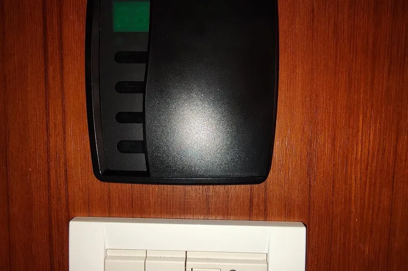 Never Enough Yacht Photos Pics Control panel and switches on Out Island SeaTek 36 Express, 2017 model, wooden background.