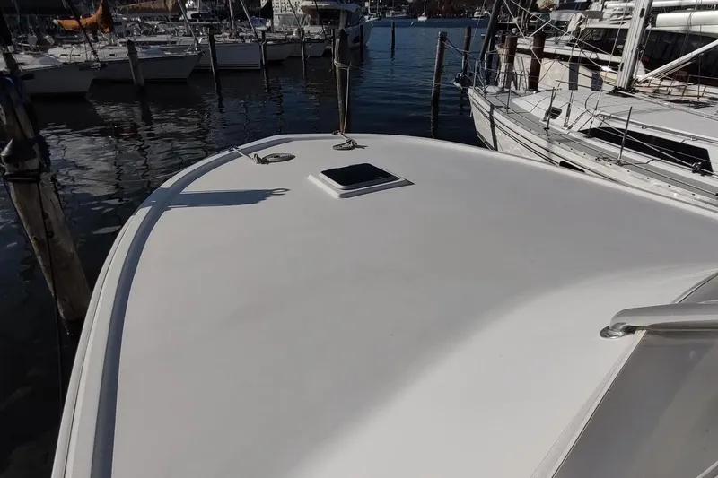 Never Enough Yacht Photos Pics 2017 Out Island SeaTek 36 Express boat docked at marina, top deck view.