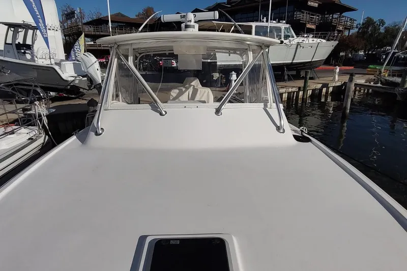 Never Enough Yacht Photos Pics 2017 Out Island SeaTek 36 Express boat docked at a marina.