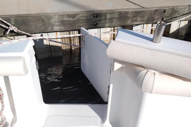 Never Enough Yacht Photos Pics 2017 Out Island SeaTek 36 Express boat with open transom door at dock.