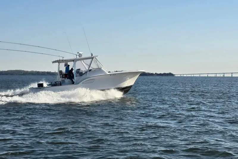 Never Enough Yacht Photos Pics 2017 Out Island SeaTek 36 Express cruising on open water under clear skies.