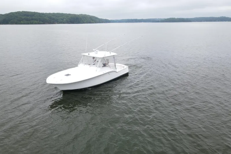 Never Enough Yacht Photos Pics 2017 Out Island SeaTek 36 Express boat cruising on a calm lake.
