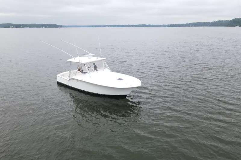 Never Enough Yacht Photos Pics 2017 Out Island SeaTek 36 Express boat on calm water, overcast sky.