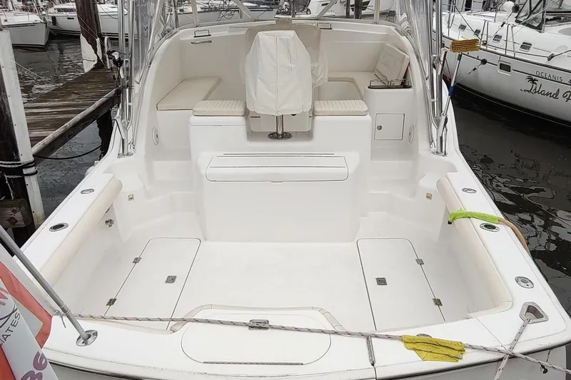 Never Enough Yacht Photos Pics 2017 Out Island SeaTek 36 Express boat docked, featuring spacious seating and clean deck design.