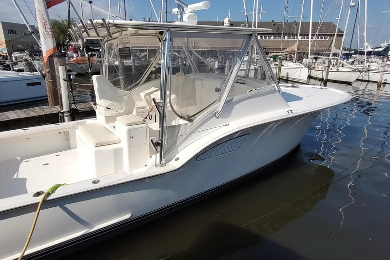 Never Enough Yacht Photos Pics 2017 Out Island SeaTek 36 Express boat docked at marina, side view.