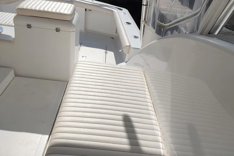 Never Enough Yacht Photos Pics 2017 Out Island SeaTek 36 Express boat interior with white cushioned seating.