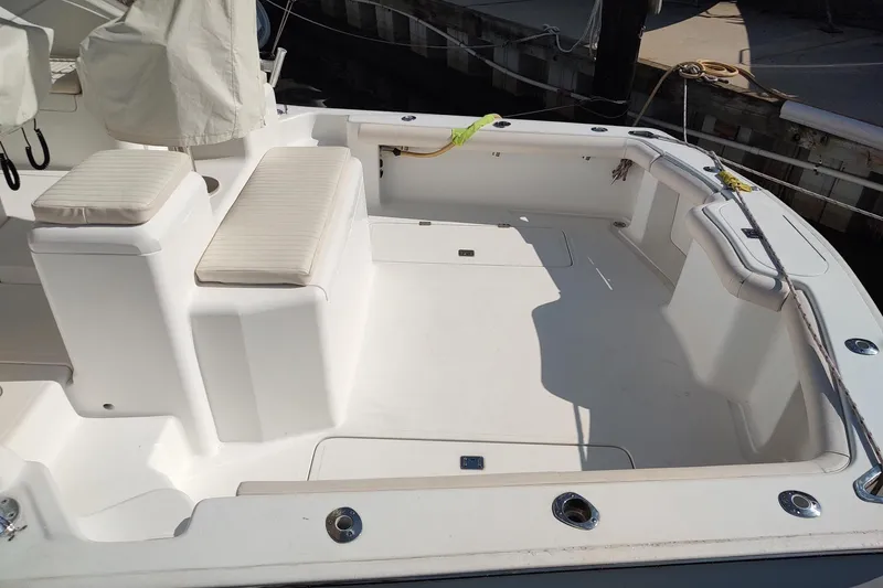 Never Enough Yacht Photos Pics 2017 Out Island SeaTek 36 Express boat deck with cushioned seating and clean white finish.