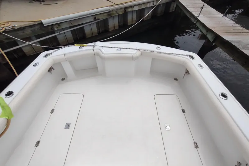 Never Enough Yacht Photos Pics 2017 Out Island SeaTek 36 Express boat deck at dock, featuring spacious seating area.