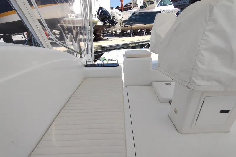 Never Enough Yacht Photos Pics 2017 Out Island SeaTek 36 Express boat interior with white seating and covered equipment.