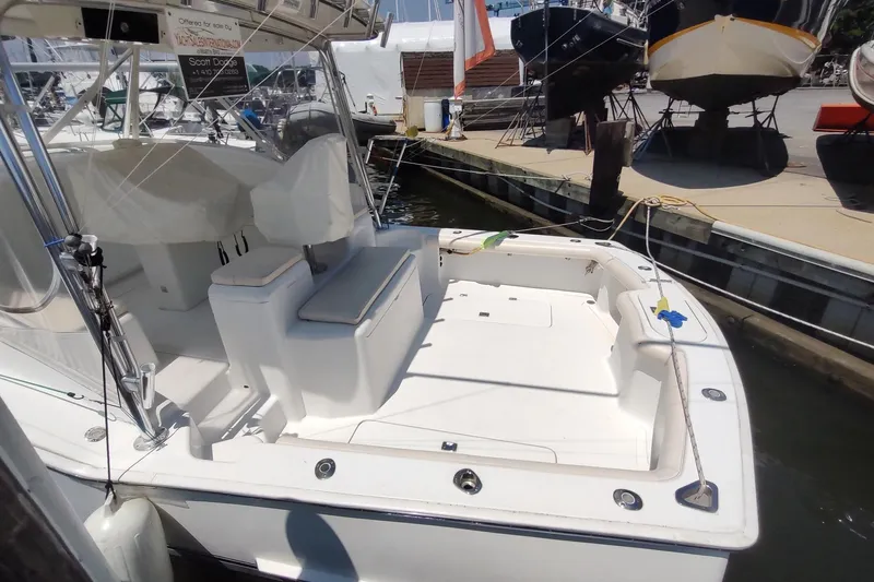 Never Enough Yacht Photos Pics 2017 Out Island SeaTek 36 Express boat docked, featuring spacious deck and seating area.