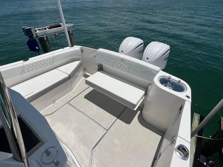  Yacht Photos Pics 2024 Regal 33 SAV boat deck with seating and twin Yamaha outboard engines.