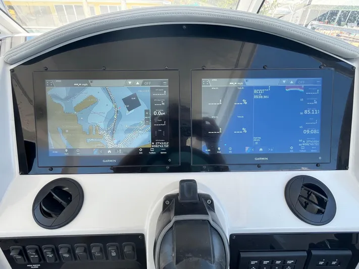  Yacht Photos Pics 2024 Regal 33 SAV dashboard with dual Garmin navigation screens displaying maps and data.