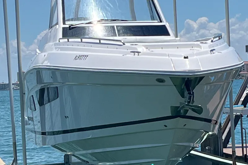  Yacht Photos Pics 2024 Regal 33 SAV boat docked, gleaming under the sun with a clear blue sky backdrop.