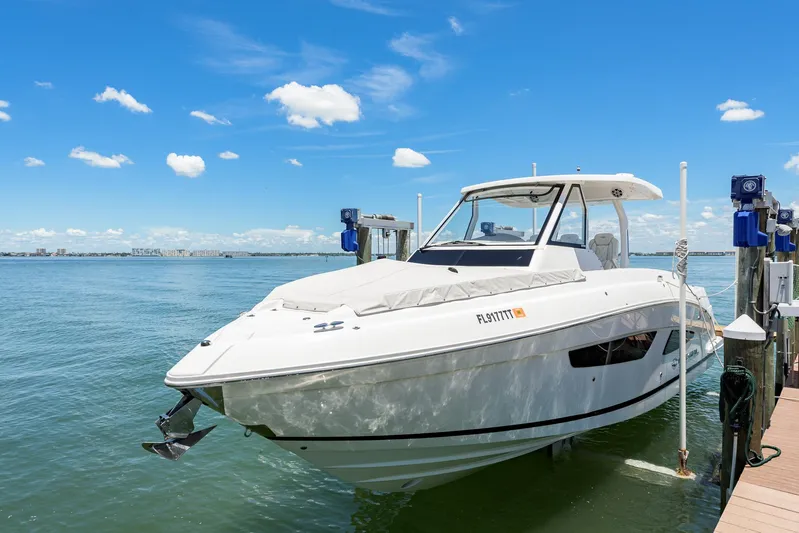  Yacht Photos Pics 2024 Regal 33 SAV boat docked on a sunny day with clear blue skies.