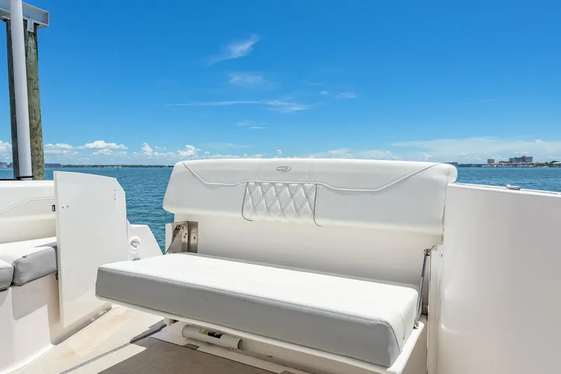  Yacht Photos Pics 2024 Regal 33 SAV boat seating with ocean view under clear blue sky.