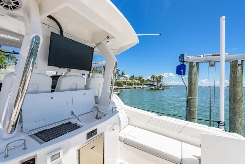  Yacht Photos Pics 2024 Regal 33 SAV boat interior with TV, grill, and waterfront view.