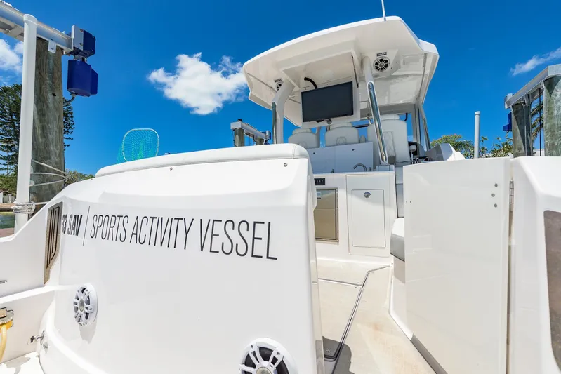  Yacht Photos Pics 2024 Regal 33 SAV sports activity vessel docked under clear blue sky.