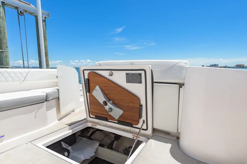  Yacht Photos Pics 2024 Regal 33 SAV boat storage compartment open on deck, under clear blue sky.