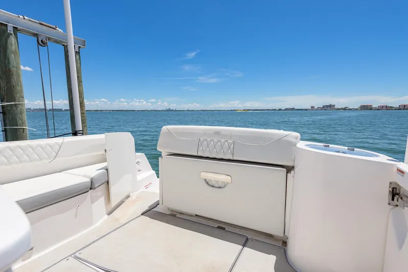  Yacht Photos Pics 2024 Regal 33 SAV boat interior with white seating, overlooking calm blue waters.