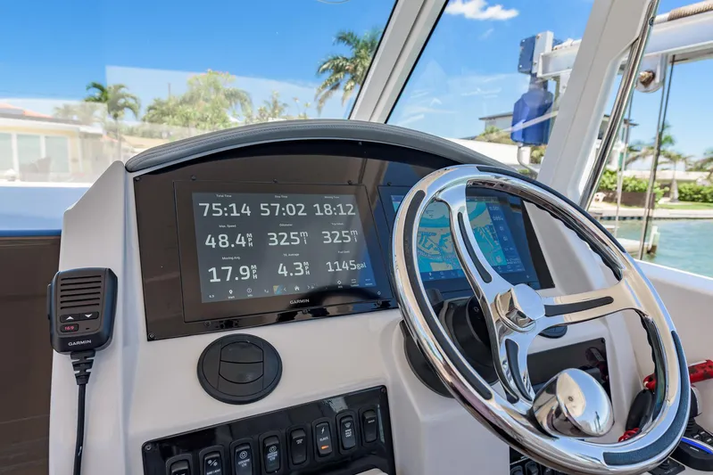  Yacht Photos Pics 2024 Regal 33 SAV boat dashboard with Garmin displays and steering wheel.
