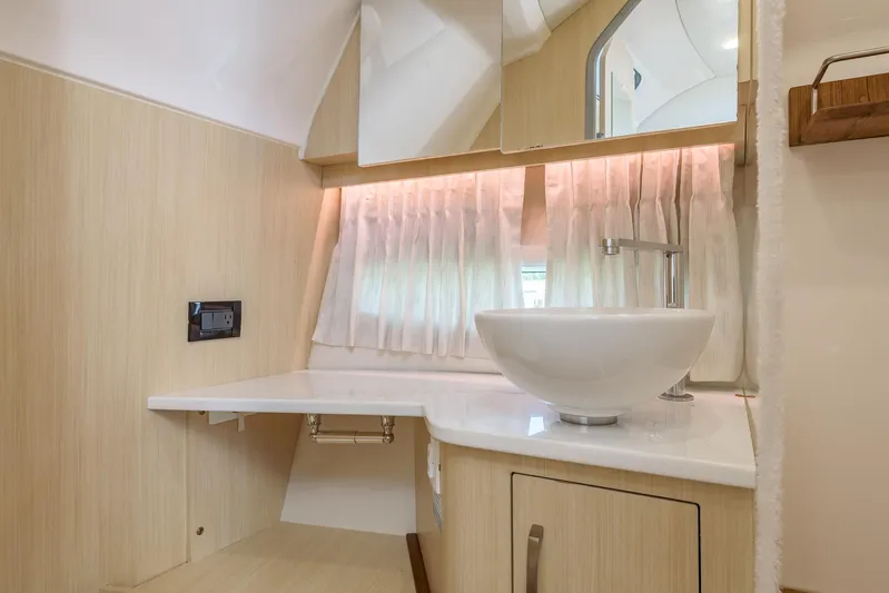  Yacht Photos Pics 2024 Regal 33 SAV bathroom with modern sink and elegant wood finish.