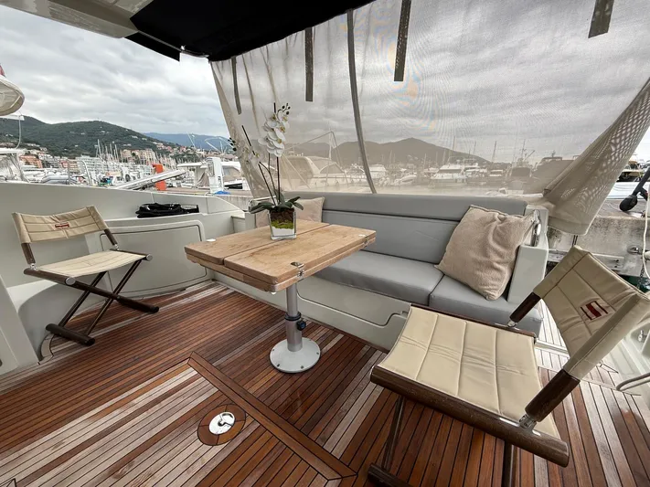  Yacht Photos Pics Luxurious 2011 Azimut 43S yacht deck with seating, wooden table, and marina view.