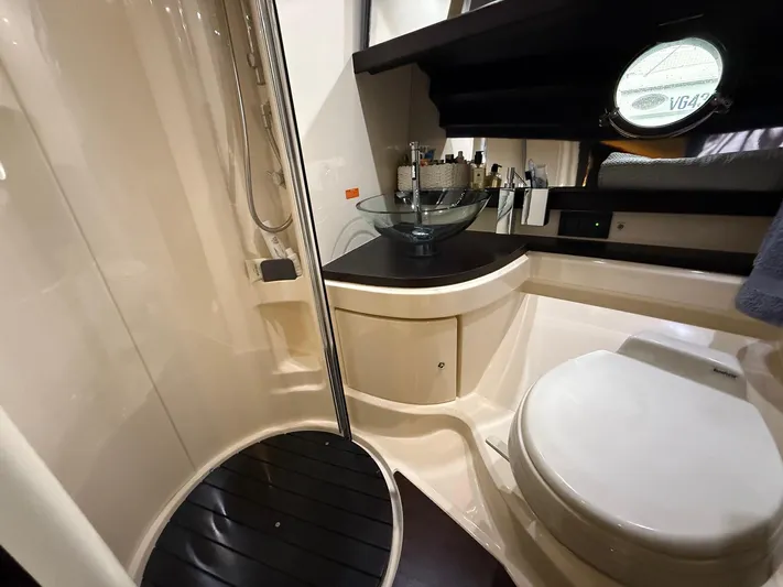  Yacht Photos Pics Luxurious bathroom in 2011 Azimut 43S yacht with modern fixtures and porthole window.