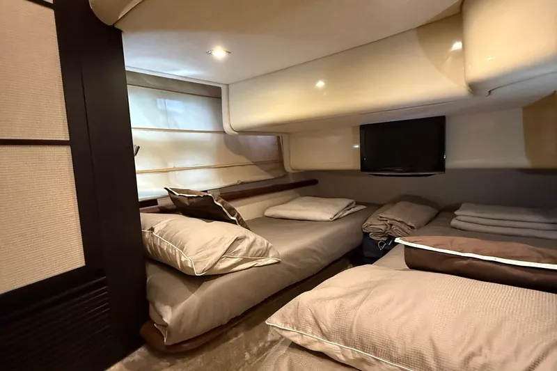  Yacht Photos Pics Luxurious cabin interior of a 2011 Azimut 43S yacht with cozy bedding and modern decor.