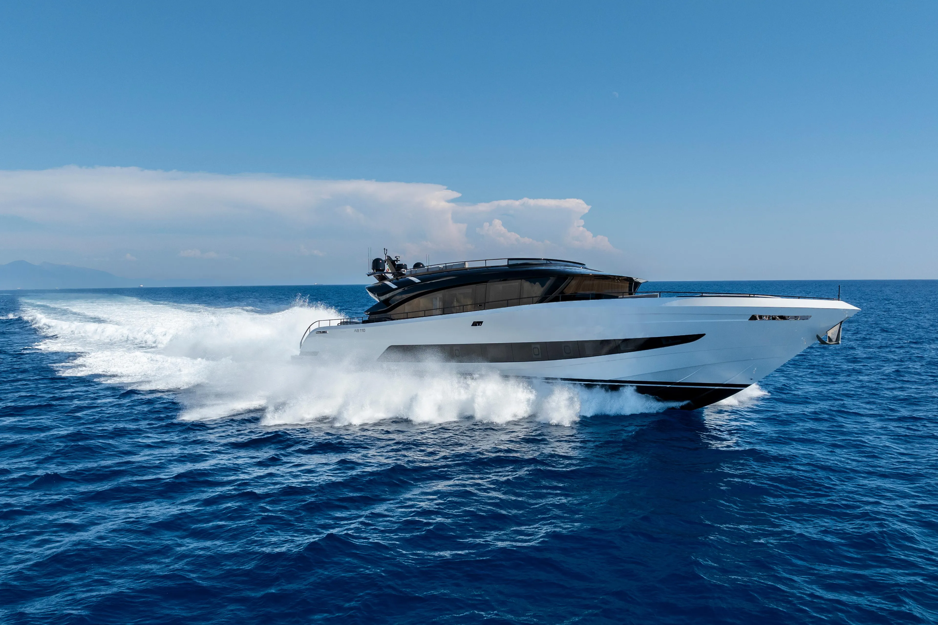 2026 AB 110 yacht cruising on open sea under clear blue sky.
