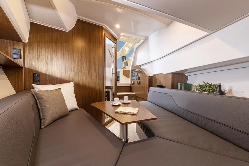 Inventory Clearance Yacht Photos Pics Luxurious interior of 2023 Bavaria Vida 33 yacht with modern seating and wooden accents.