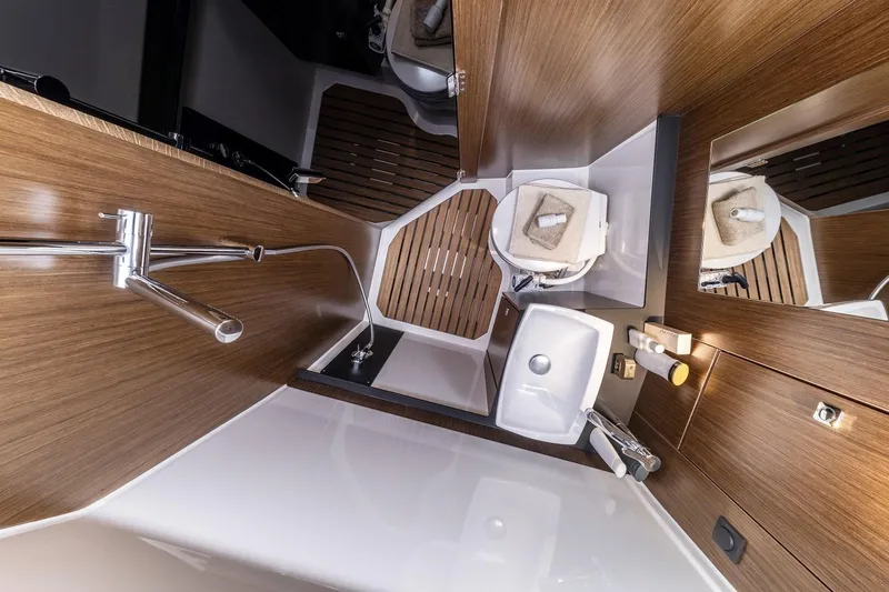 Inventory Clearance Yacht Photos Pics Modern bathroom interior of 2023 Bavaria Vida 33 yacht, featuring wood accents and sleek fixtures.