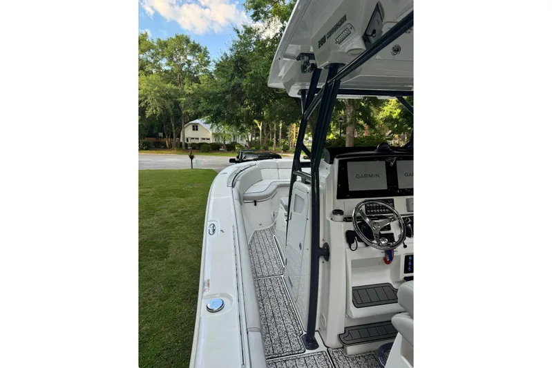  Yacht Photos Pics 2021 Sea Fox 288 Commander boat interior with Garmin navigation, parked on grass.