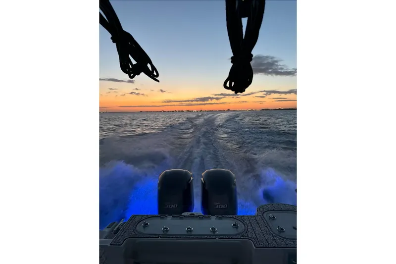  Yacht Photos Pics 2021 Sea Fox 288 Commander cruising at sunset with illuminated wake.