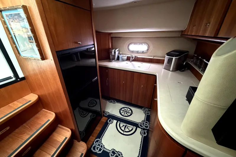  Yacht Photos Pics 2006 Tiara Yachts 4300 Sovran galley with wood cabinetry and modern appliances.