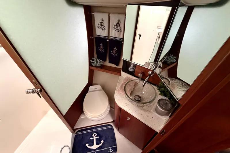  Yacht Photos Pics Luxurious 2006 Tiara Yachts 4300 Sovran bathroom with nautical decor and modern amenities.