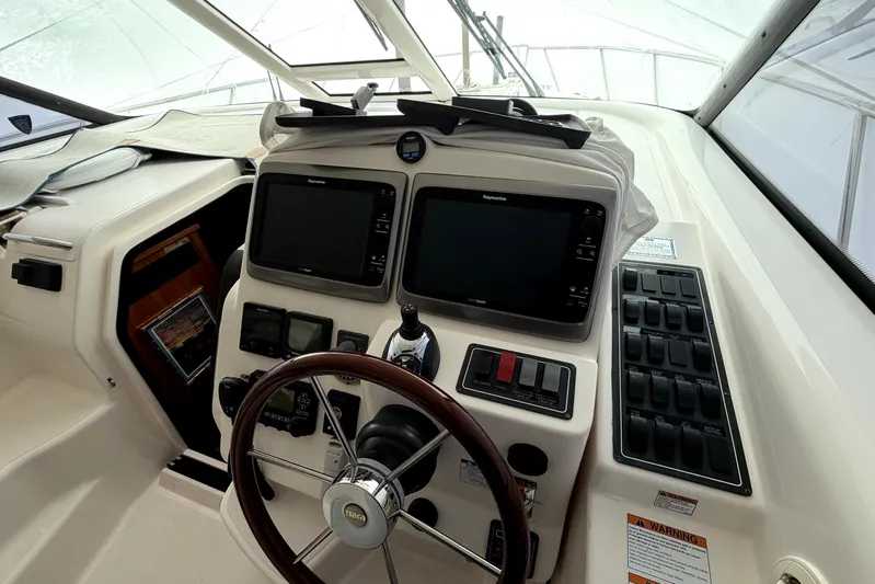  Yacht Photos Pics 2006 Tiara Yachts 4300 Sovran helm with dual Raymarine displays and wooden steering wheel.