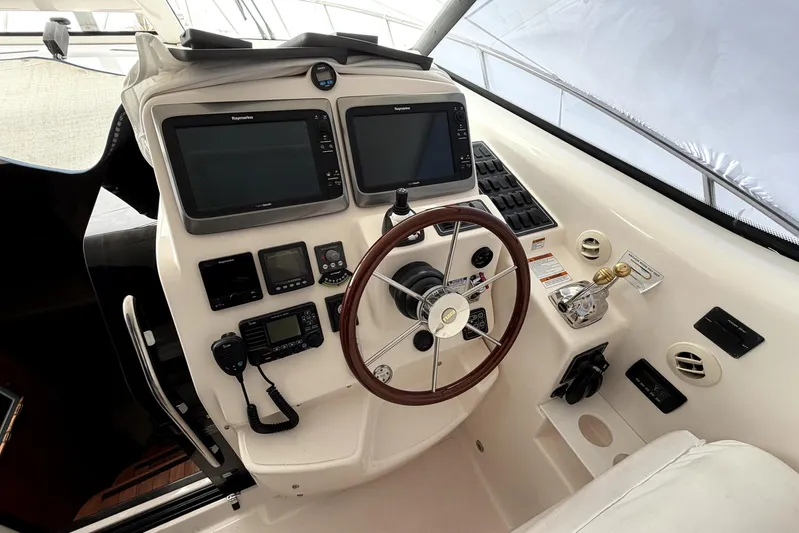  Yacht Photos Pics Helm of 2006 Tiara Yachts 4300 Sovran with dual Raymarine displays and wooden steering wheel.