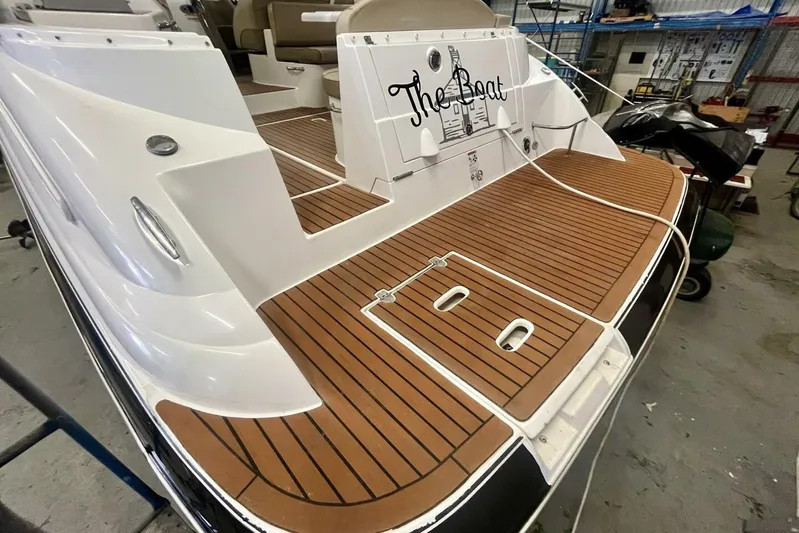  Yacht Photos Pics 2011 Cruisers Yachts 330 Express with teak deck in a workshop setting.