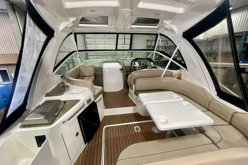  Yacht Photos Pics 2011 Cruisers Yachts 330 Express interior with seating, table, and helm in a sleek design.